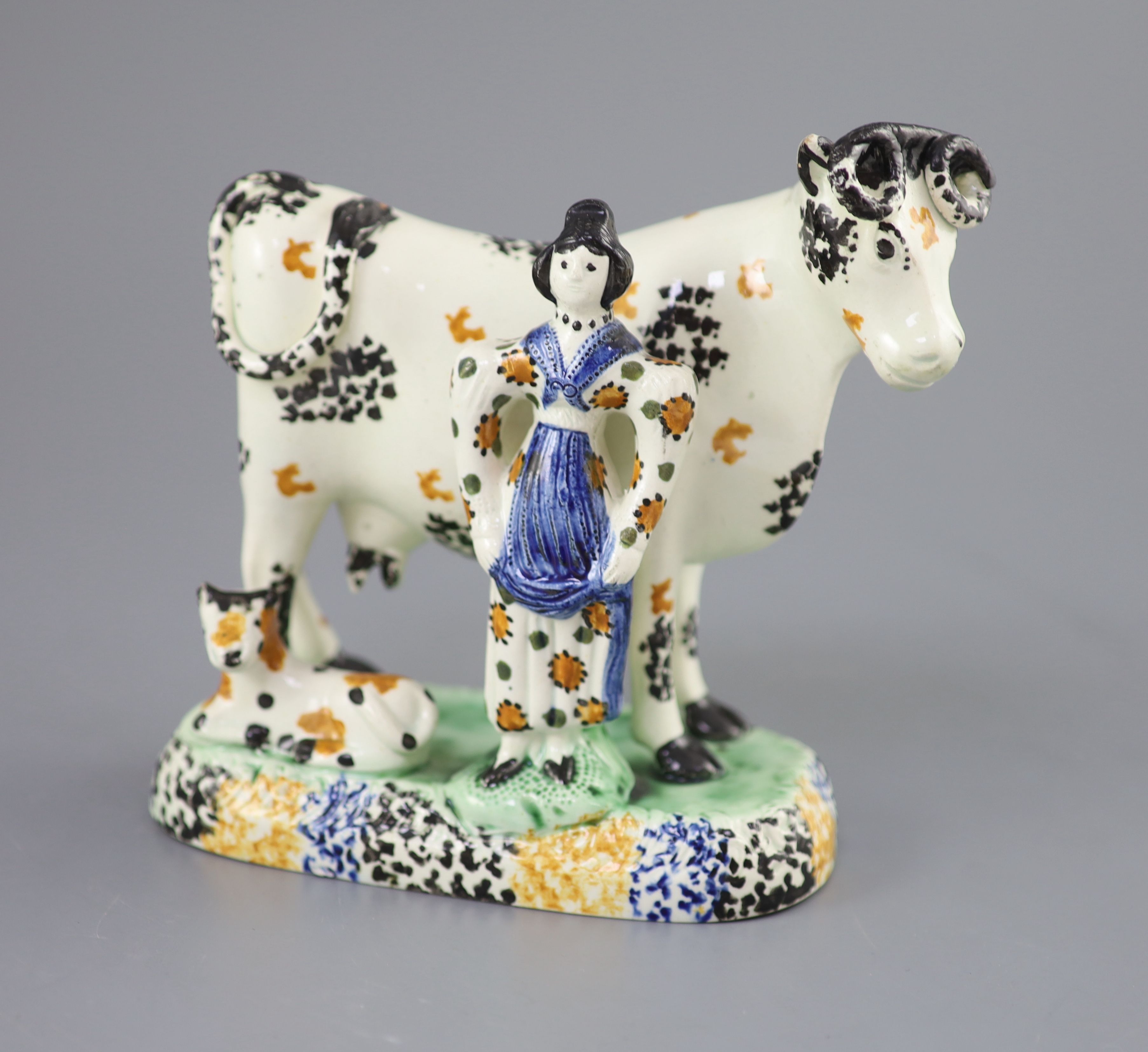 A Yorkshire Prattware cow and milkmaid group, probably Mexborough, c.1820, 15cm high, 16cm long